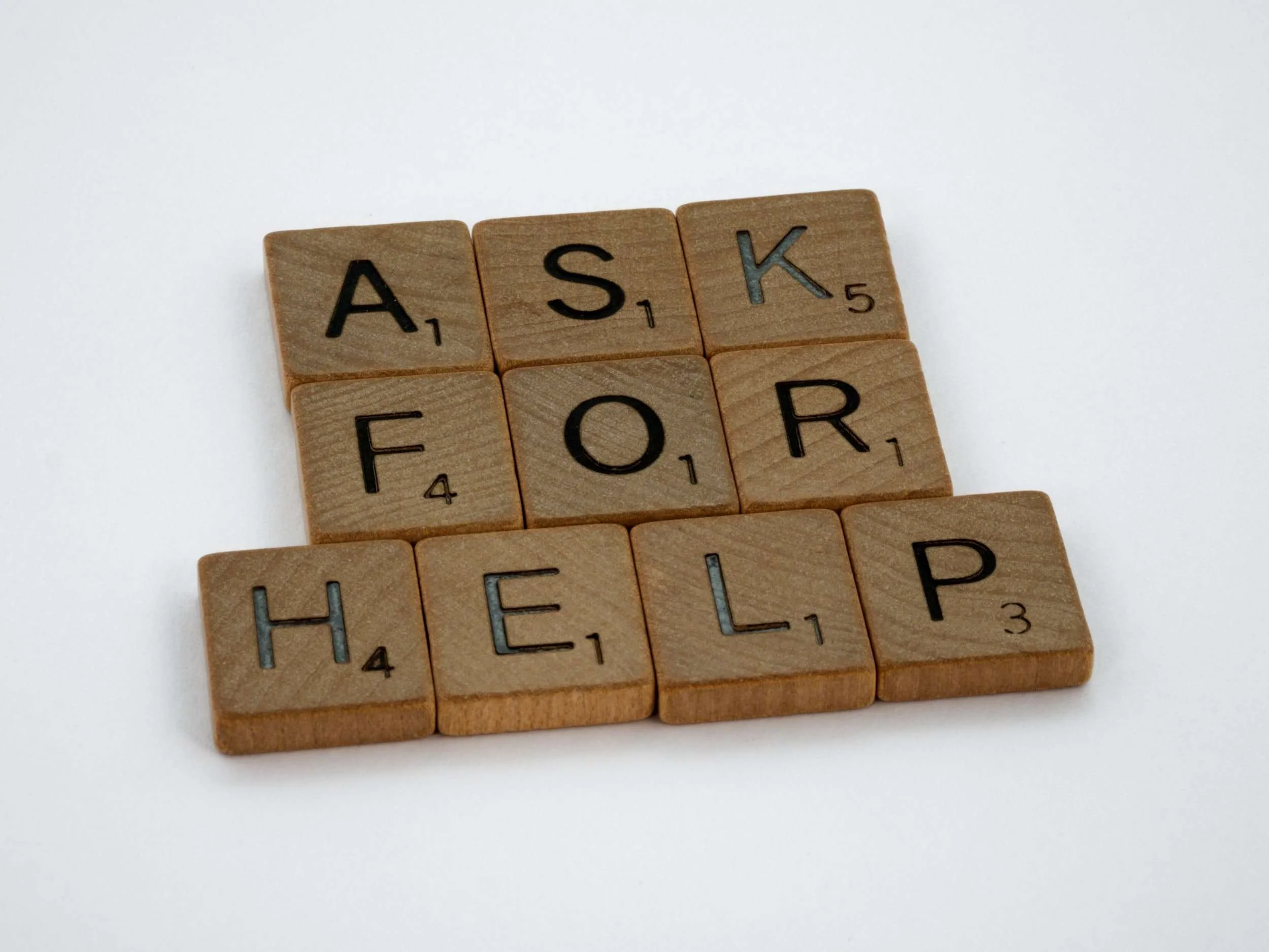 Scrabble letters spelled "ASK FOR HELP"